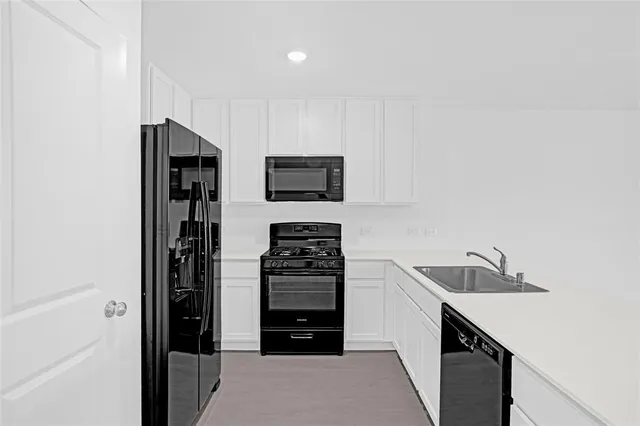 a kitchen with stainless steel appliances a refrigerator and a stove top oven