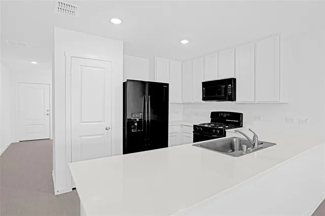 a bedroom with a bed and a flat tv screen in it