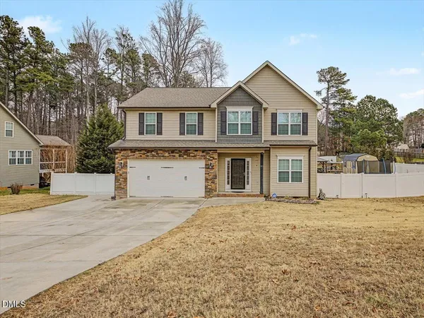 a front view of a house with a yard and garage