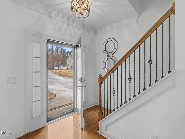 a view of a hallway with wooden floor and staircase