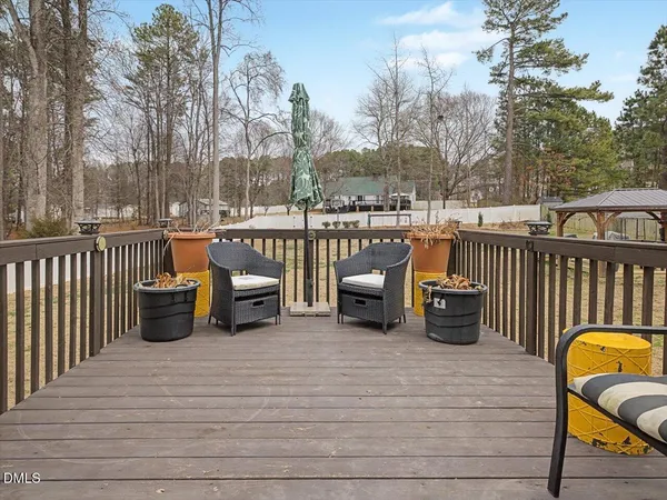 a roof deck with table and chairs couches with wooden fence