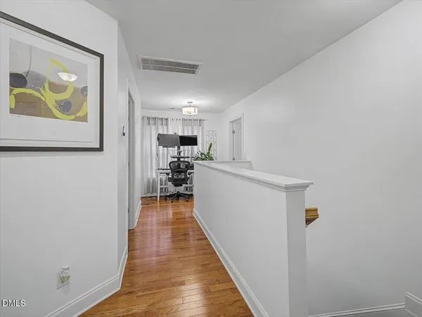 a view of a workspace with furniture and a potted plant