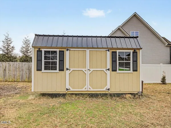 a view of a house with a yard and garage