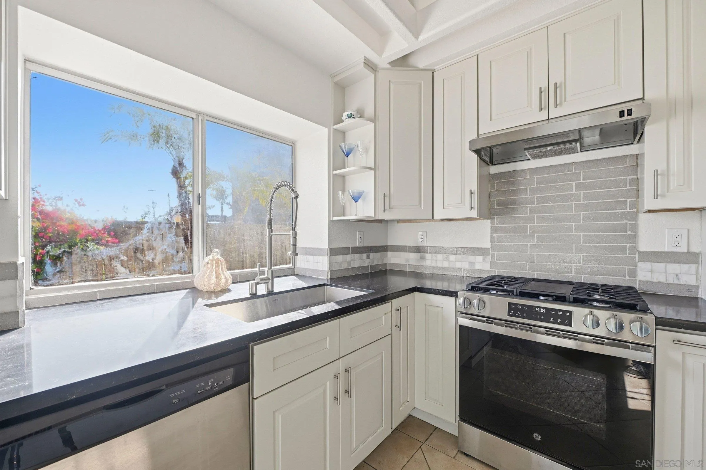 4290 Via Clemente Oceanside, CA 92057 - Photo 16 of 34 a kitchen with stainless steel appliances white cabinets and a stove top oven