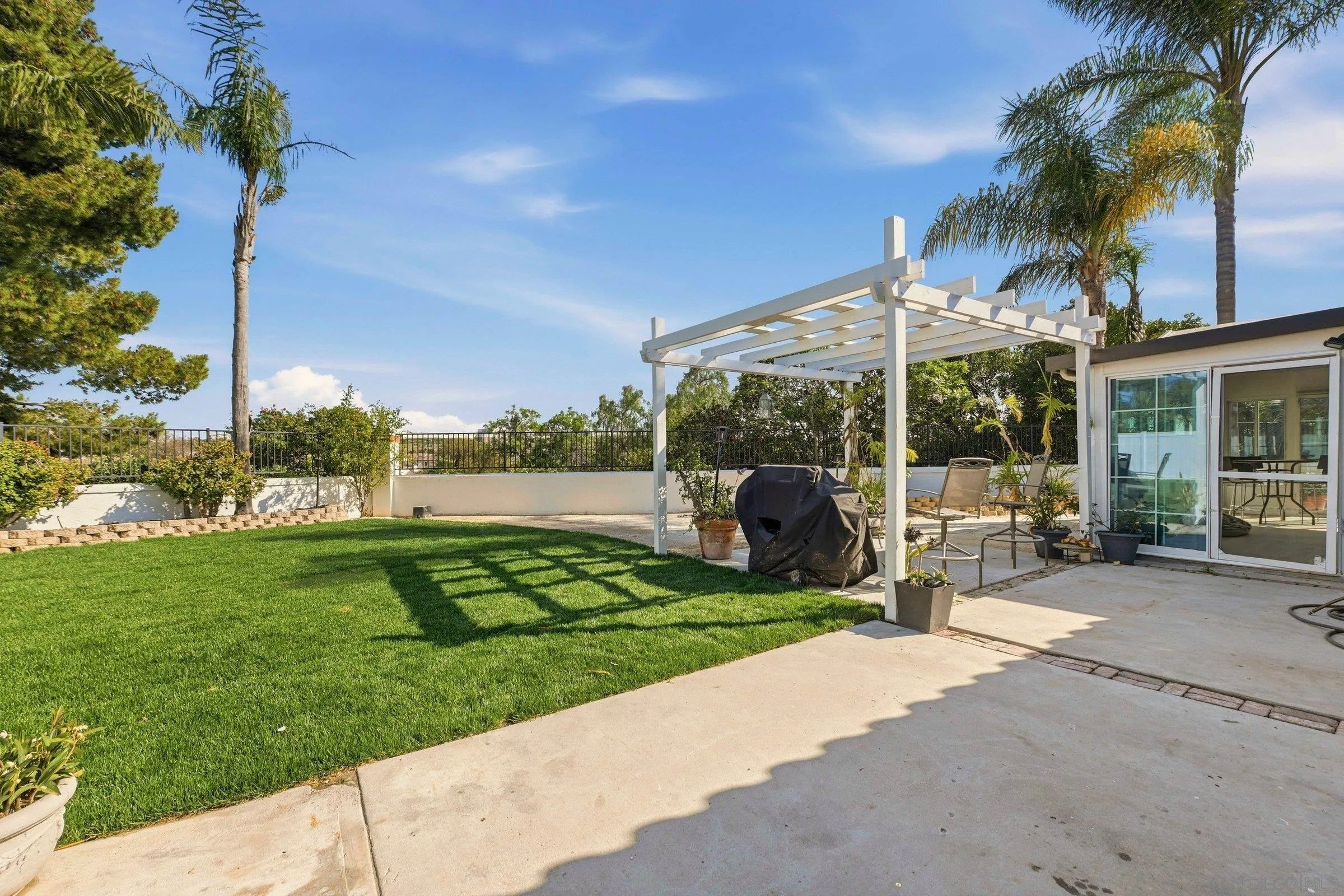 4290 Via Clemente Oceanside, CA 92057 - Photo 31 of 34 a view of a chair and tables in the patio in front of a house