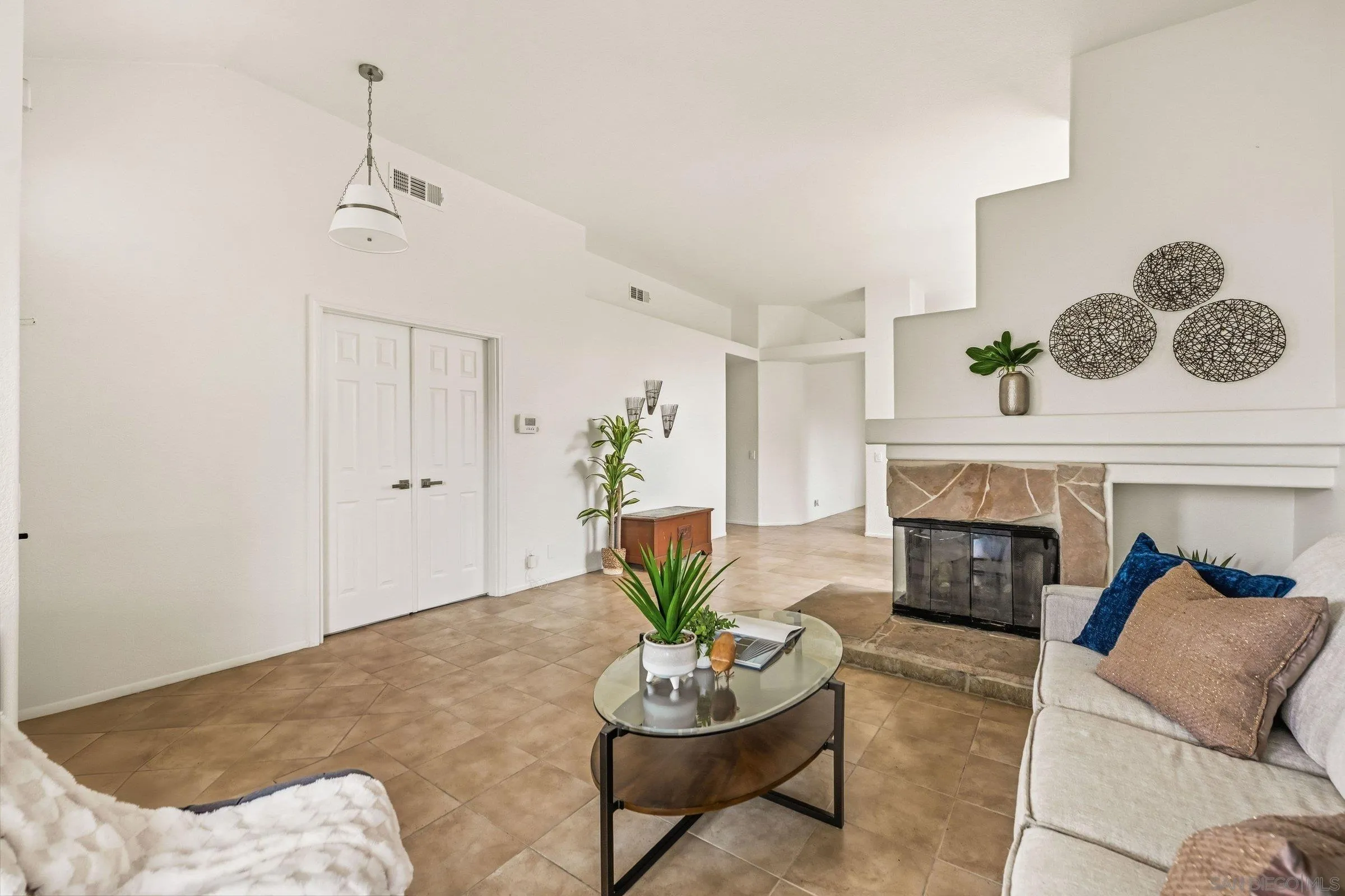 4290 Via Clemente Oceanside, CA 92057 - Photo 10 of 34 a living room with furniture a fireplace and a potted plant