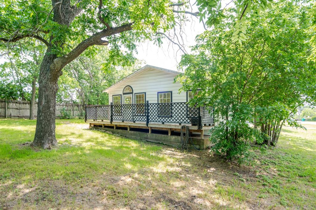 199 B.C. Rhome Avenue Rhome, TX 76078 - Photo 3 of 34 a view of a house with a yard and sitting area
