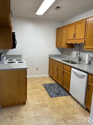 a kitchen with stainless steel appliances granite countertop a sink stove and cabinets