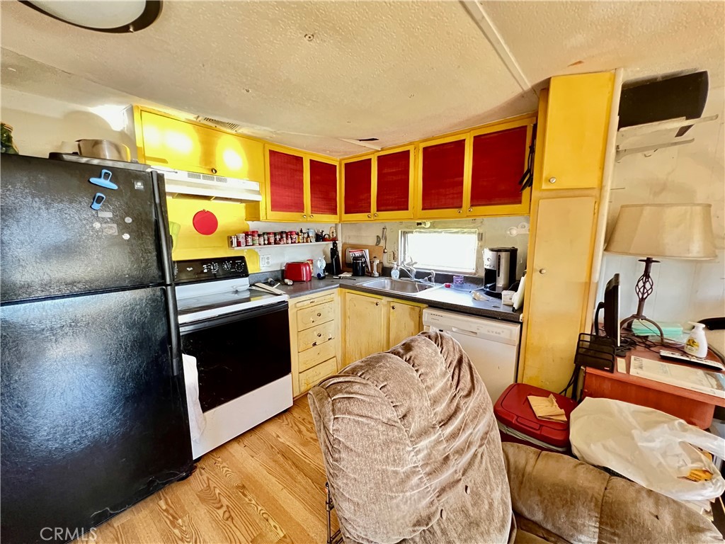 13517 Arrowhead Road Clearlake, CA 95422 - Photo 18 of 37 a kitchen with stainless steel appliances granite countertop a sink and cabinets