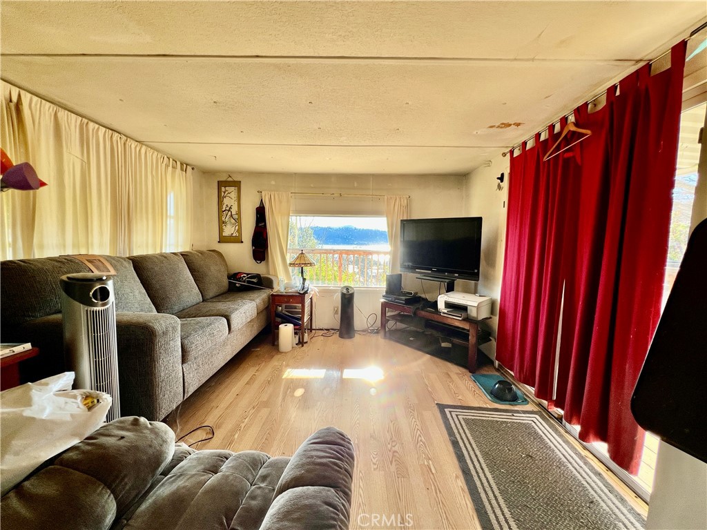 13517 Arrowhead Road Clearlake, CA 95422 - Photo 19 of 37 a living room with furniture and a flat screen tv