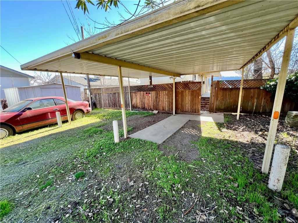 13517 Arrowhead Road Clearlake, CA 95422 - Photo 35 of 37 a view of a backyard with a table and chairs under an umbrella