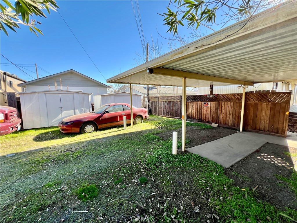 13517 Arrowhead Road Clearlake, CA 95422 - Photo 36 of 37 a backyard of a house with table and chairs under an umbrella