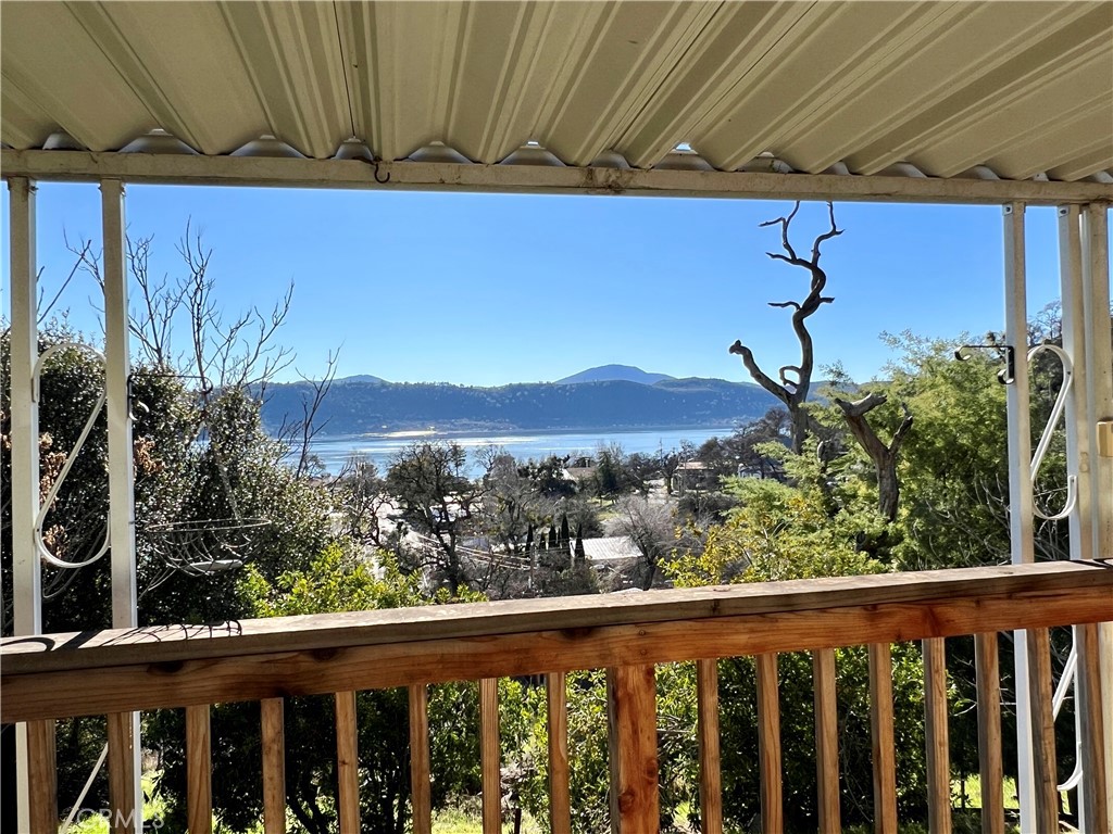 13517 Arrowhead Road Clearlake, CA 95422 - Photo 5 of 37 a view of a balcony with a swing chair and wooden fence