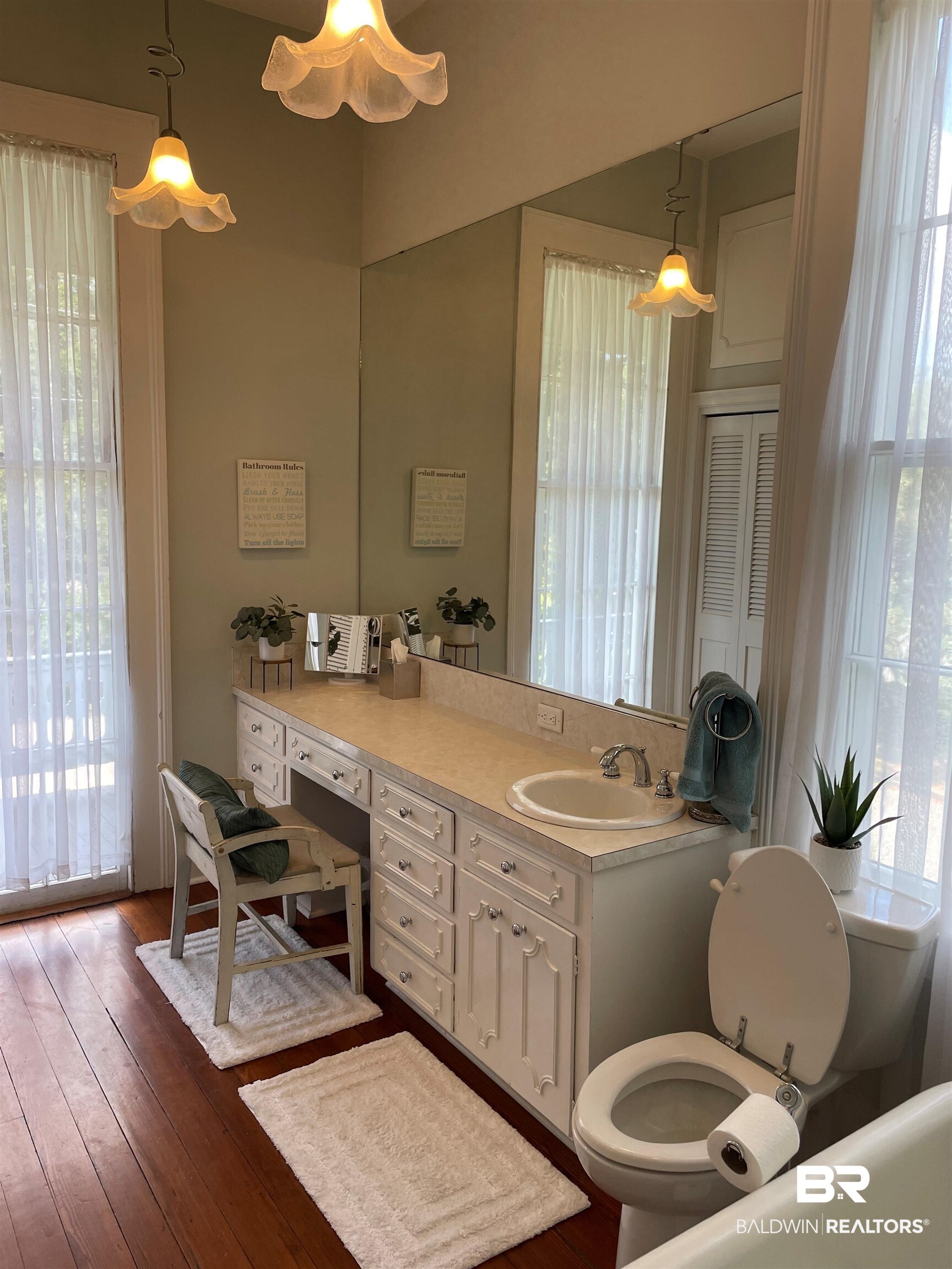 1001 Augusta Street Mobile, AL 36604 - Photo 25 of 26 Bathroom featuring toilet, a wealth of natural light, and hardwood / wood-style floors