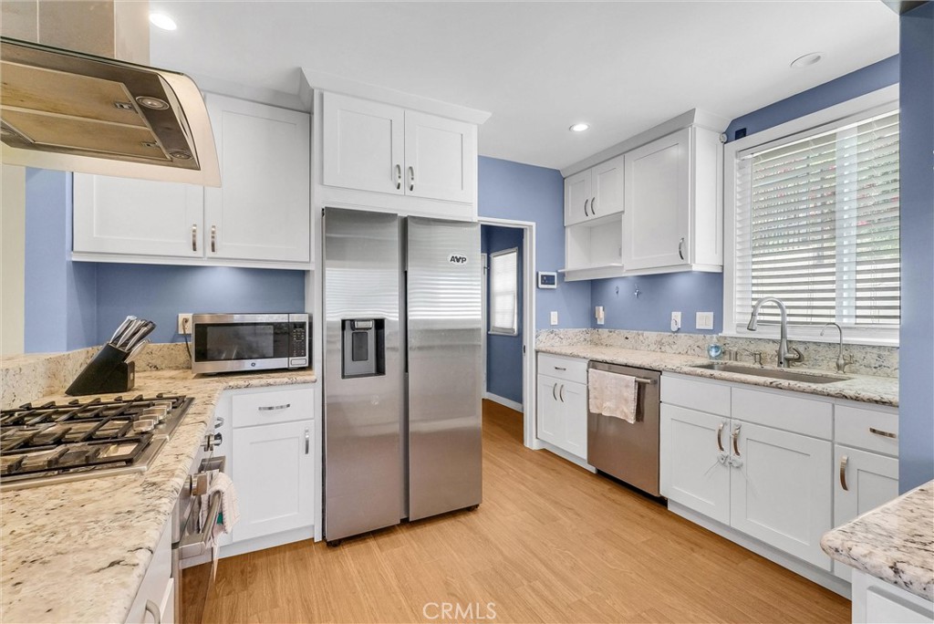 918 Dorothea Road La Habra Heights, CA 90631 - Photo 15 of 42 a kitchen with stainless steel appliances granite countertop a stove a sink and a refrigerator