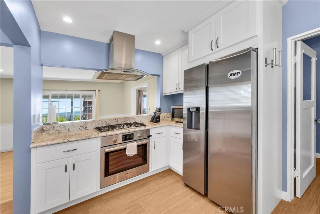 918 Dorothea Road La Habra Heights, CA 90631 - Photo 17 of 42 a kitchen with stainless steel appliances granite countertop a stove a refrigerator and a refrigerator
