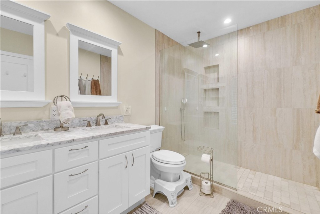 918 Dorothea Road La Habra Heights, CA 90631 - Photo 20 of 42 a bathroom with a toilet a sink a mirror a shower a vanity and window