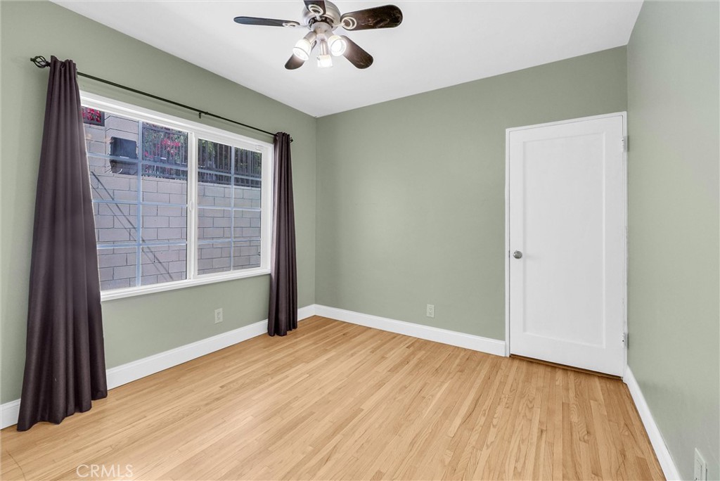 918 Dorothea Road La Habra Heights, CA 90631 - Photo 24 of 42 an empty room with wooden floor fan and windows
