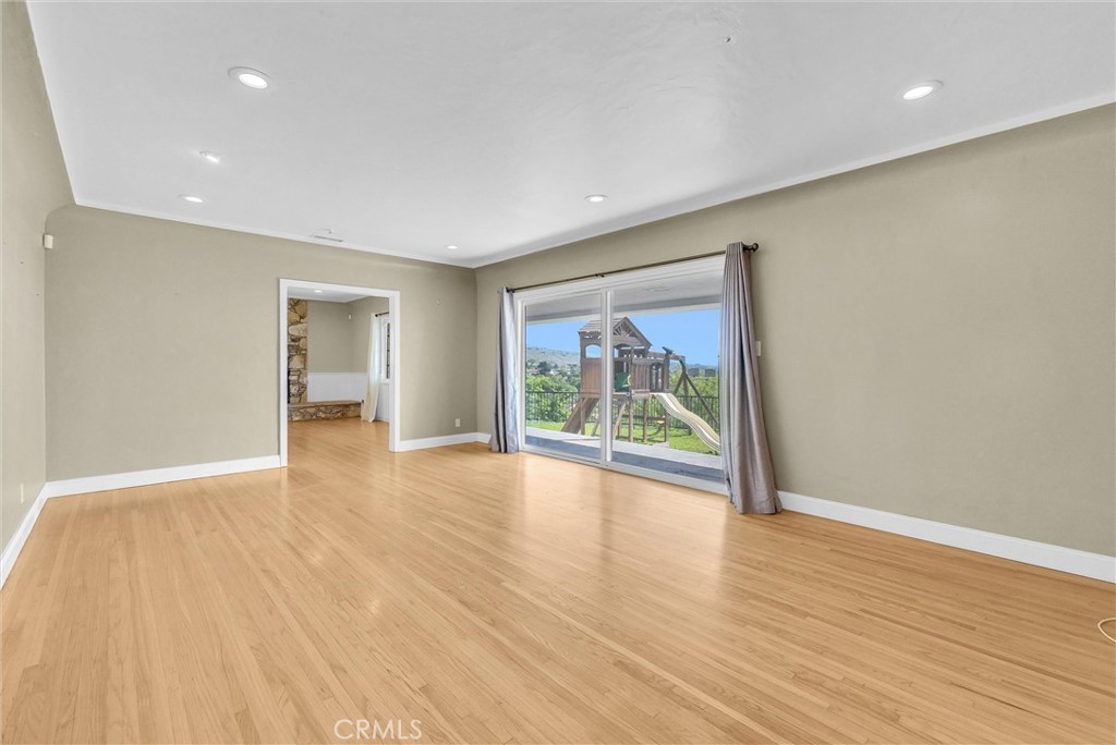 918 Dorothea Road La Habra Heights, CA 90631 - Photo 9 of 42 a view of an empty room with wooden floor and a window