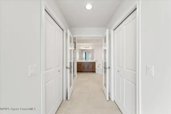 a spacious bathroom with a tub double sink and mirror