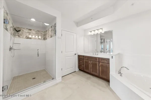 a bathroom with a shower sink vanity mirror and toilet