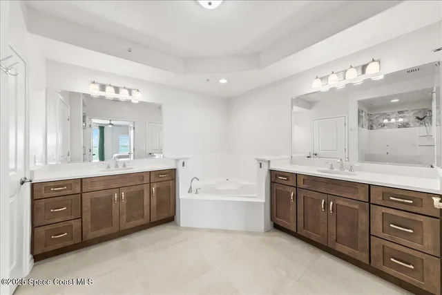 a bathroom with a shower sink vanity mirror and toilet