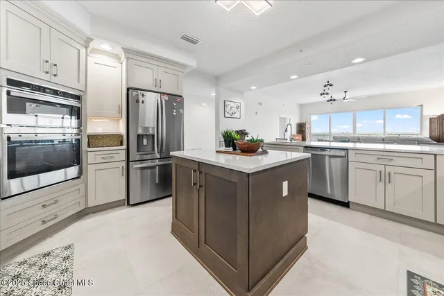 a kitchen with white cabinets appliances and a sink