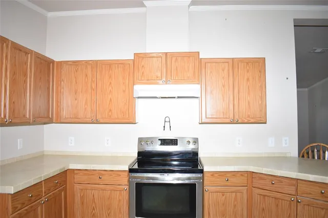 a kitchen with a sink stove top oven and cabinets
