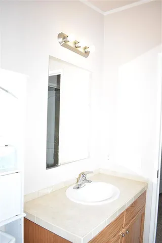 a bathroom with a granite countertop bathtub toilet and sink