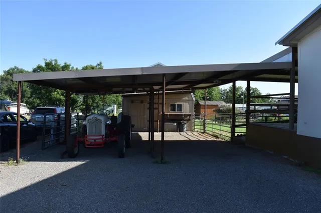 a view of a patio with a table and chairs under an umbrella with a patio