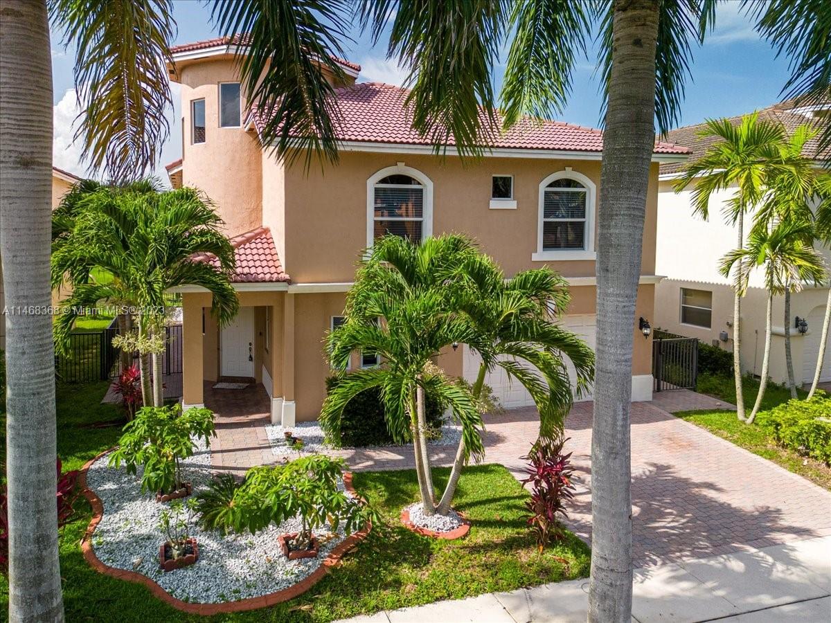 12441 Southwest 1st Street Plantation, FL 33325 - Photo 1 of 37 a front view of house with yard and green space