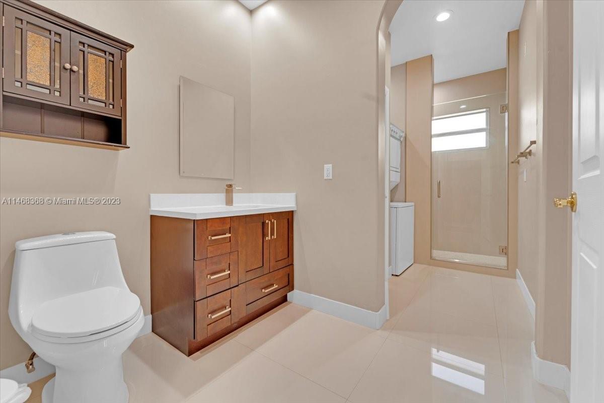 12441 Southwest 1st Street Plantation, FL 33325 - Photo 12 of 37 a bathroom with a toilet sink vanity and mirror