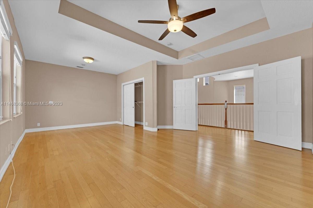 12441 Southwest 1st Street Plantation, FL 33325 - Photo 20 of 37 a view of empty room with wooden floor and fan
