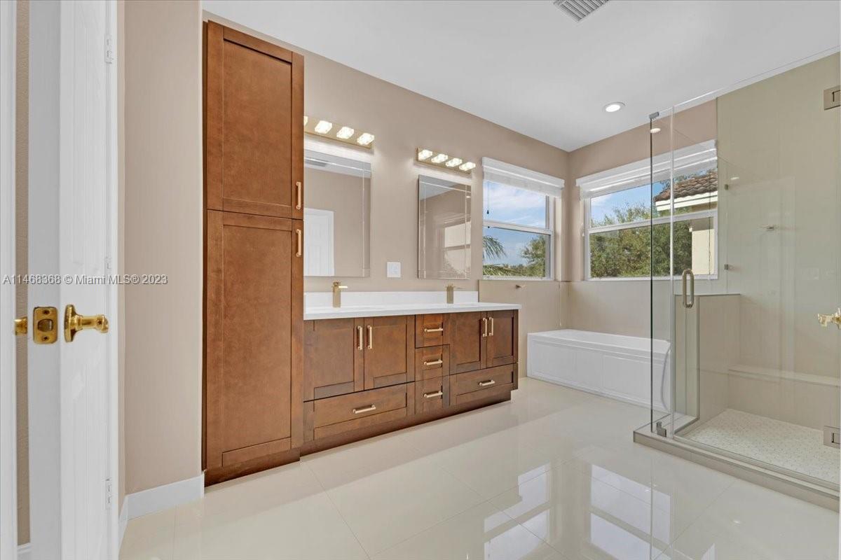 12441 Southwest 1st Street Plantation, FL 33325 - Photo 21 of 37 a spacious bathroom with a tub sink shower and mirror