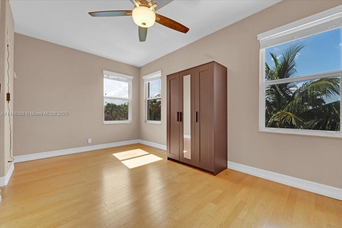 12441 Southwest 1st Street Plantation, FL 33325 - Photo 24 of 37 an empty room with windows and ceiling fan