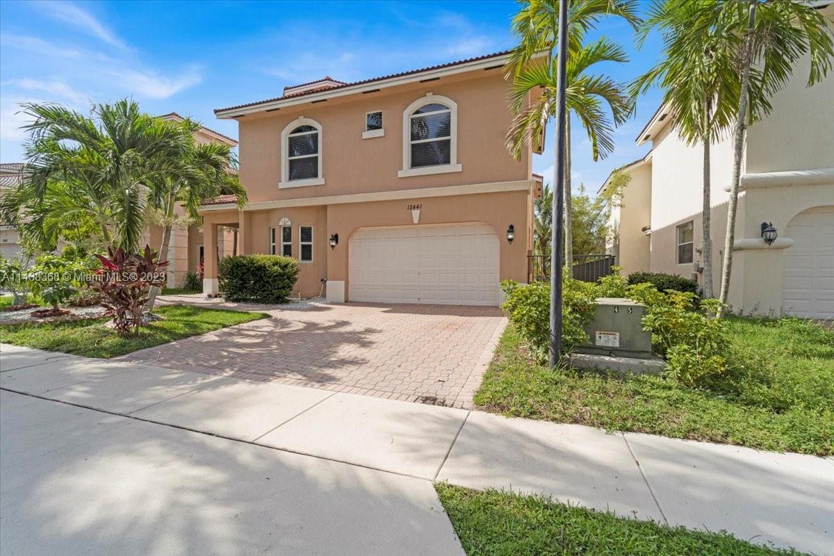 12441 Southwest 1st Street Plantation, FL 33325 - Photo 3 of 37 a front view of a house with garden