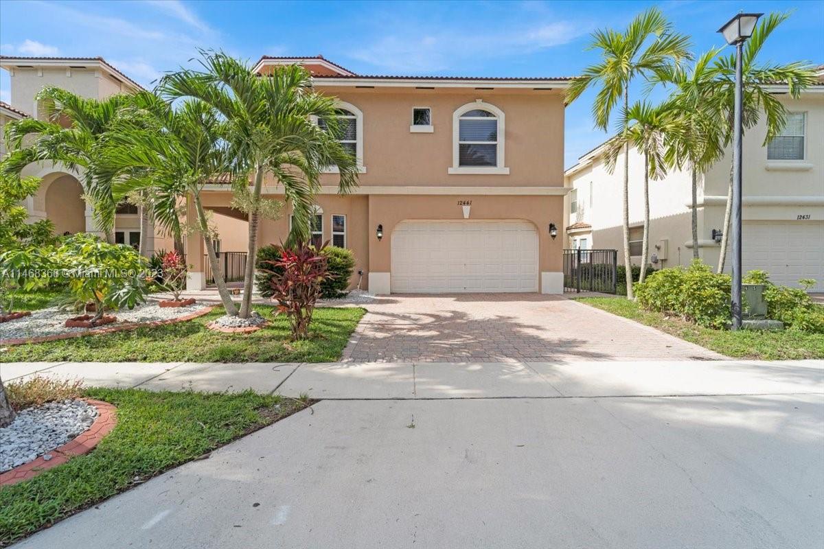 12441 Southwest 1st Street Plantation, FL 33325 - Photo 36 of 37 a front view of a house with garden