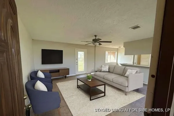 a living room with furniture and a flat screen tv