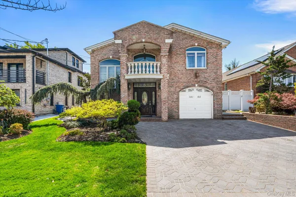 a front view of a house with a garden and yard