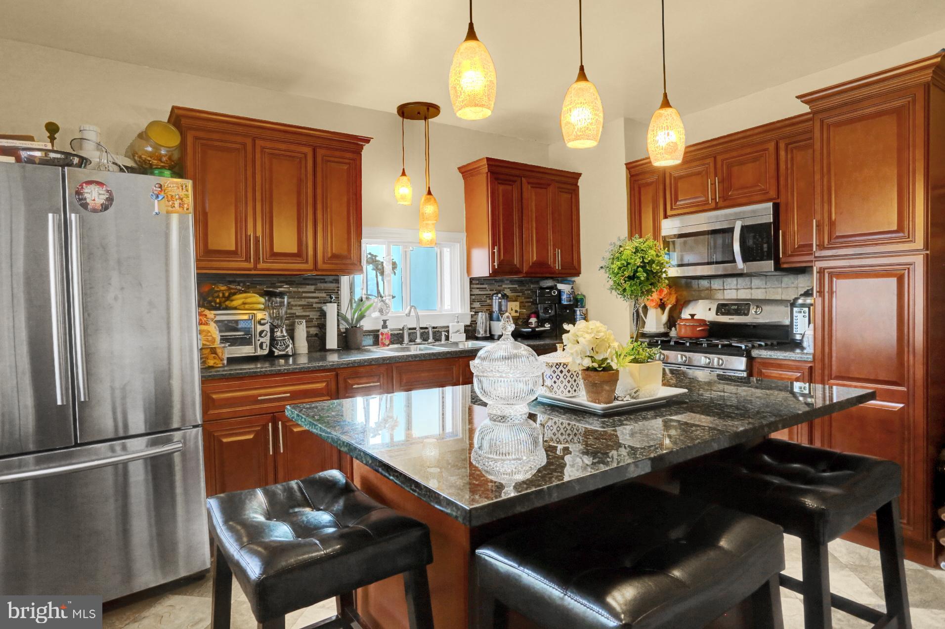 1742 Mineral Spring Road Reading, PA 19602 - Photo 12 of 31 a kitchen with stainless steel appliances granite countertop a sink refrigerator and microwave