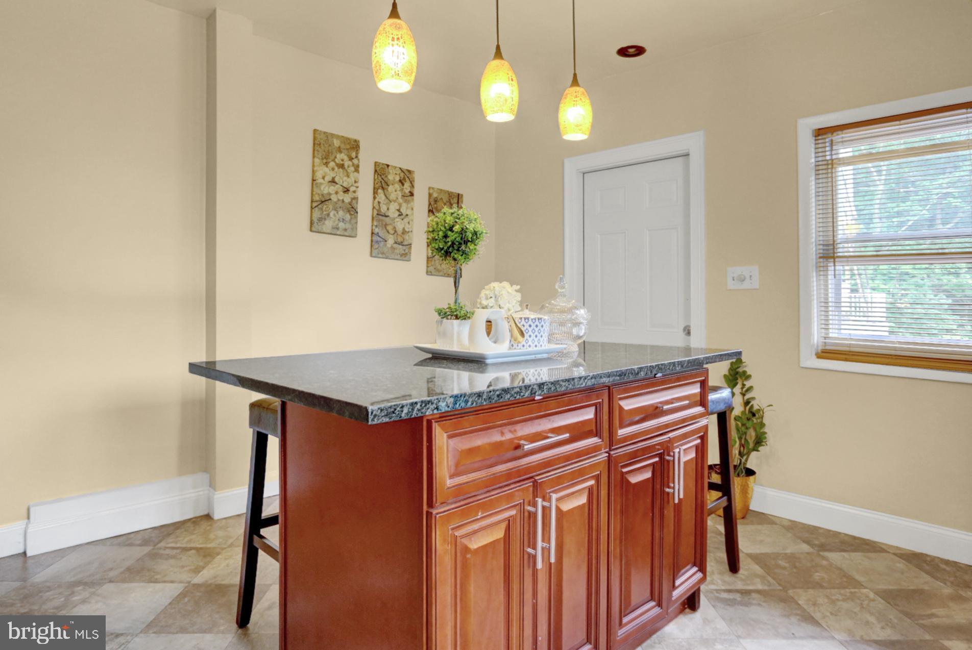 1742 Mineral Spring Road Reading, PA 19602 - Photo 14 of 31 a kitchen area with granite countertop cabinets and wooden floor