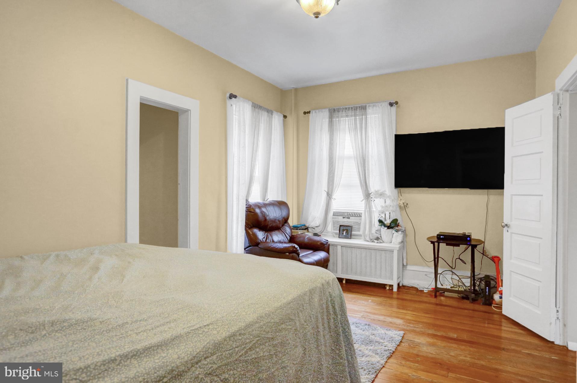 1742 Mineral Spring Road Reading, PA 19602 - Photo 21 of 31 a large bedroom with a bed and a flat tv screen on dresser
