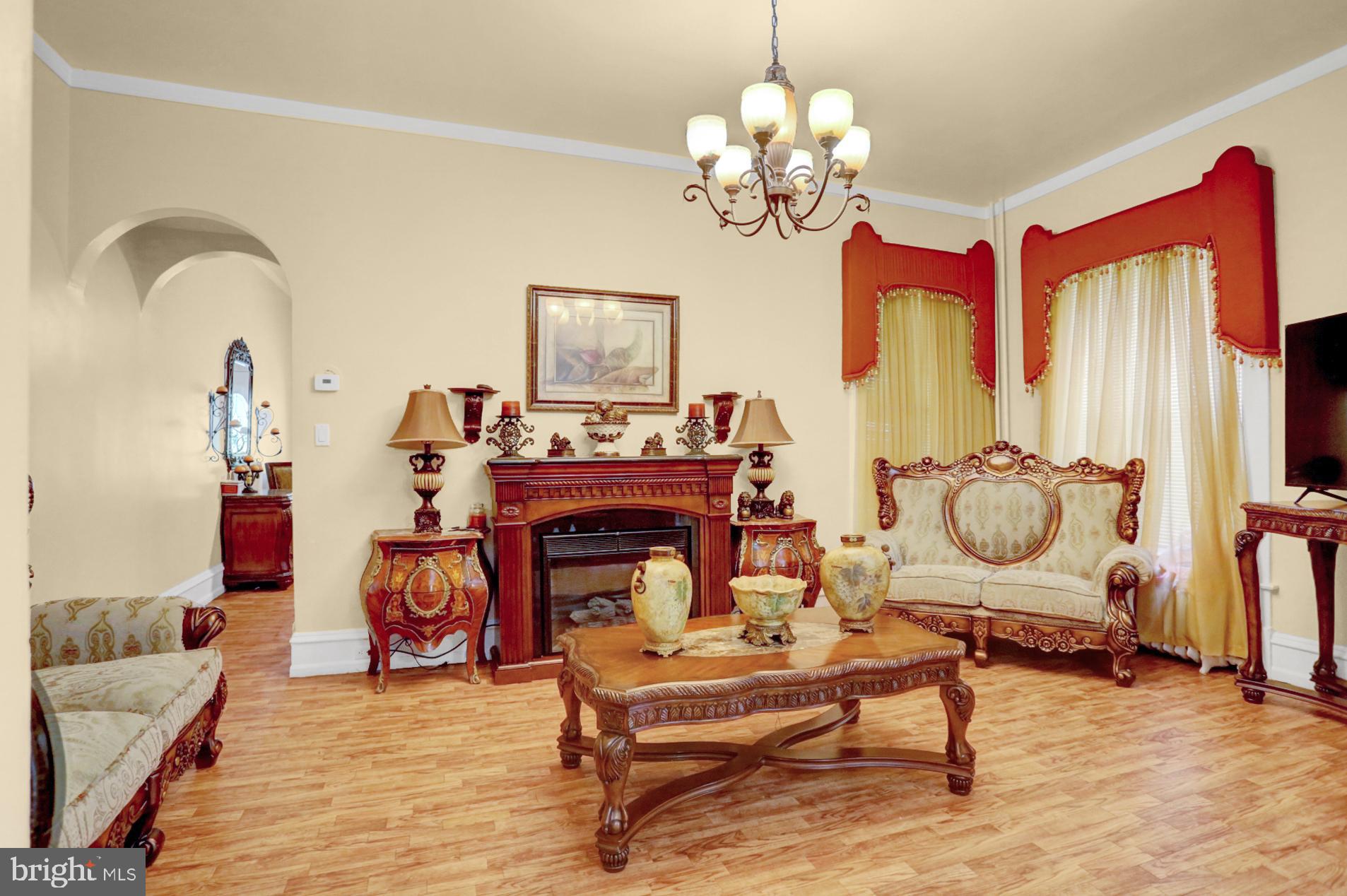 1742 Mineral Spring Road Reading, PA 19602 - Photo 8 of 31 a living room with furniture a chandelier and a fireplace