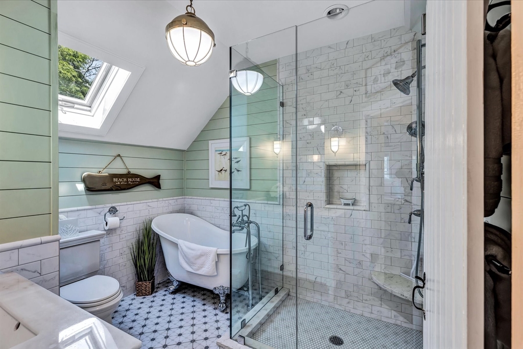 21 Milestone Way, Unit 620 Mashpee, MA 02649 - Photo 21 of 28 a bathroom with a sink a toilet a mirror and shower