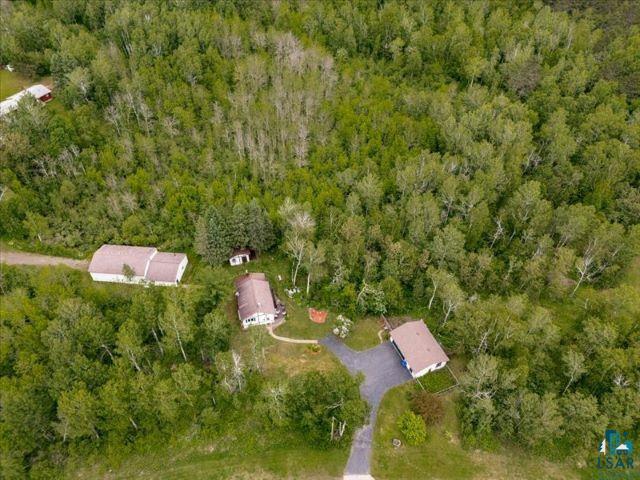 3616 Lavaque Road Hermantown, MN 55811 - Photo 12 of 43 Expansive wooded acreage featuring a main residence, a detached garage, and a large outbuilding