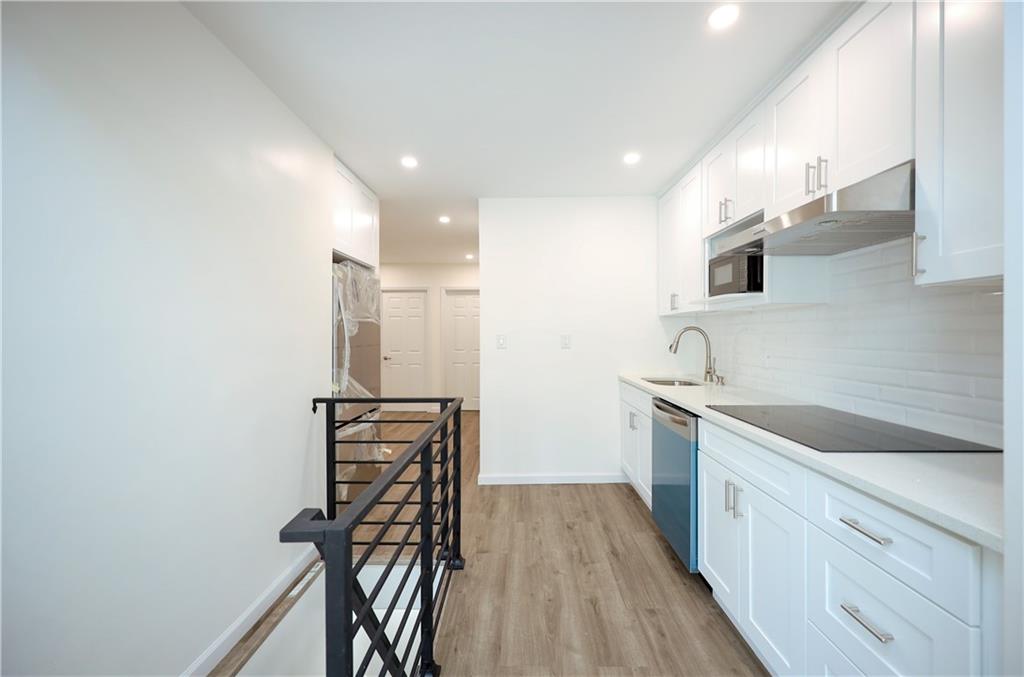 1940 20th Drive Brooklyn, NY 11214 - Photo 4 of 21 a kitchen with a sink stainless steel appliances and cabinets