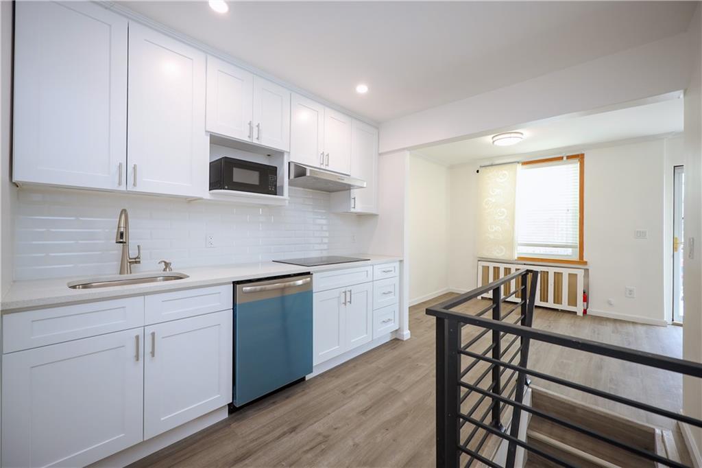1940 20th Drive Brooklyn, NY 11214 - Photo 5 of 21 a kitchen with sink cabinets and microwave