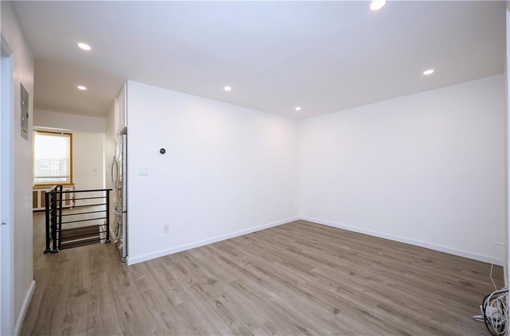 1940 20th Drive Brooklyn, NY 11214 - Photo 7 of 21 an empty room with wooden floor and entrance