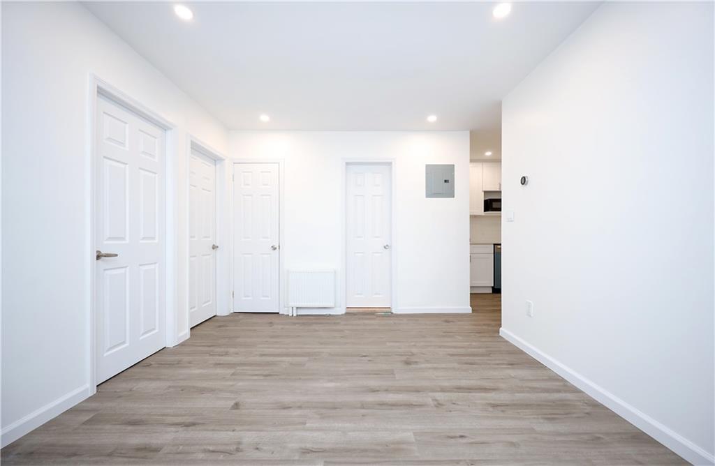 1940 20th Drive Brooklyn, NY 11214 - Photo 8 of 21 a view of empty room with wooden floor