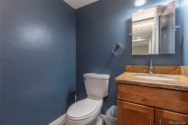 a bathroom with a sink a toilet and mirror